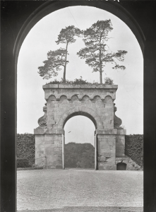 The great arch and its fantastic overgrowth seen from the entrance to Eastbury House. The trees are still there today. Country Life 03/09/1927
